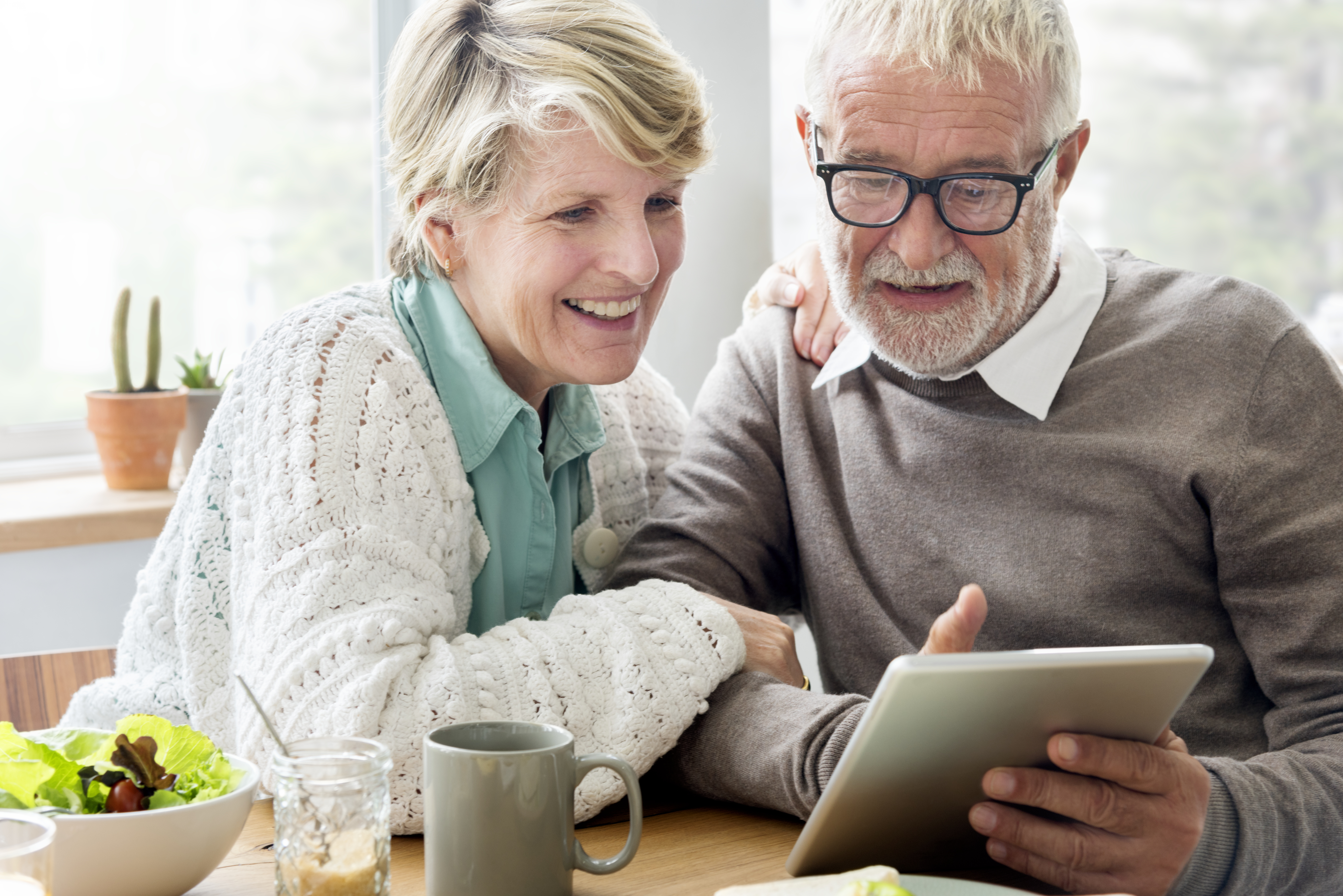 senior-couple-using-tablet-to-explore-life-insurance-options-for-cancer-patients