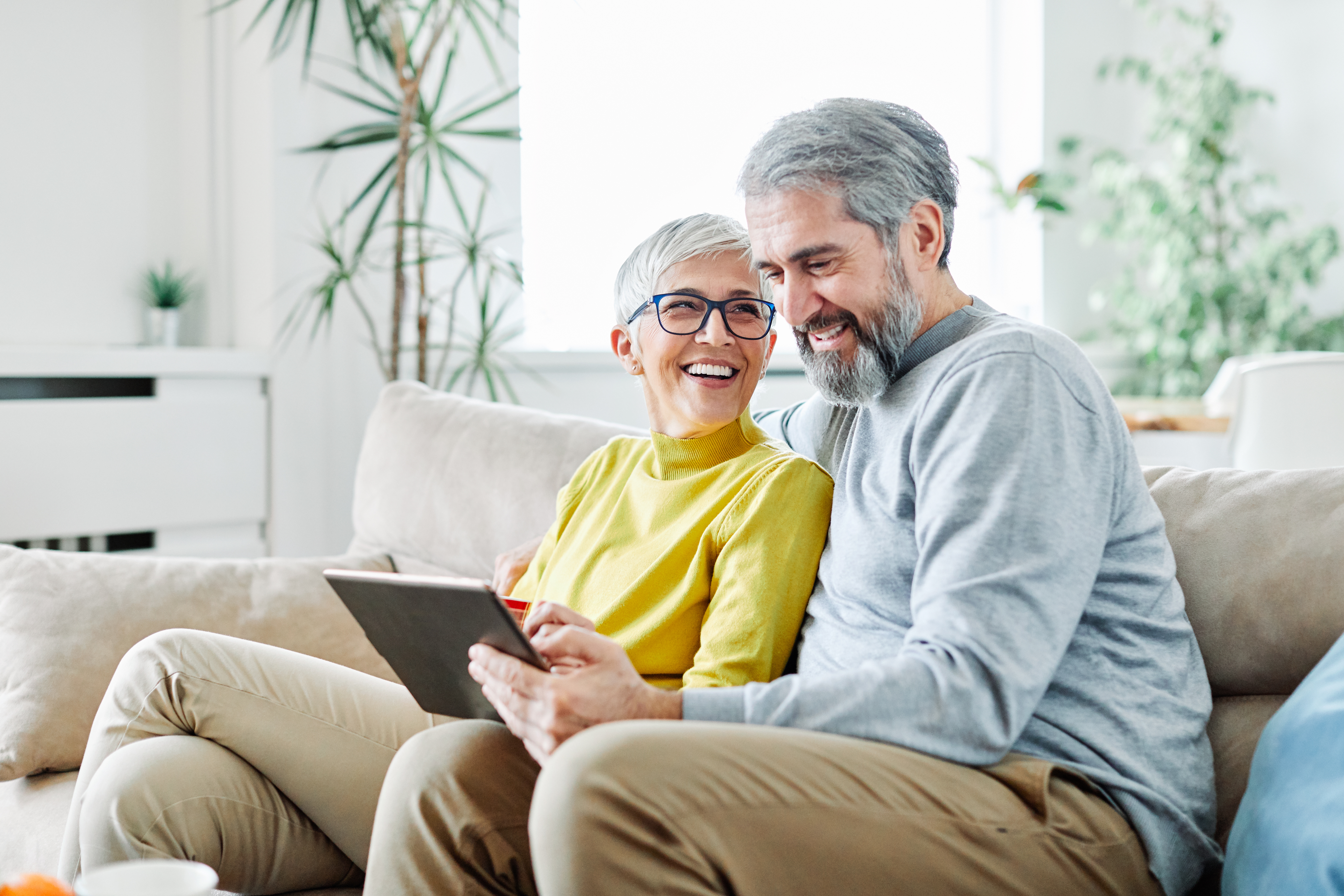 couple-exploring-life-insurance-options-with-osteoporosis-on-tablet