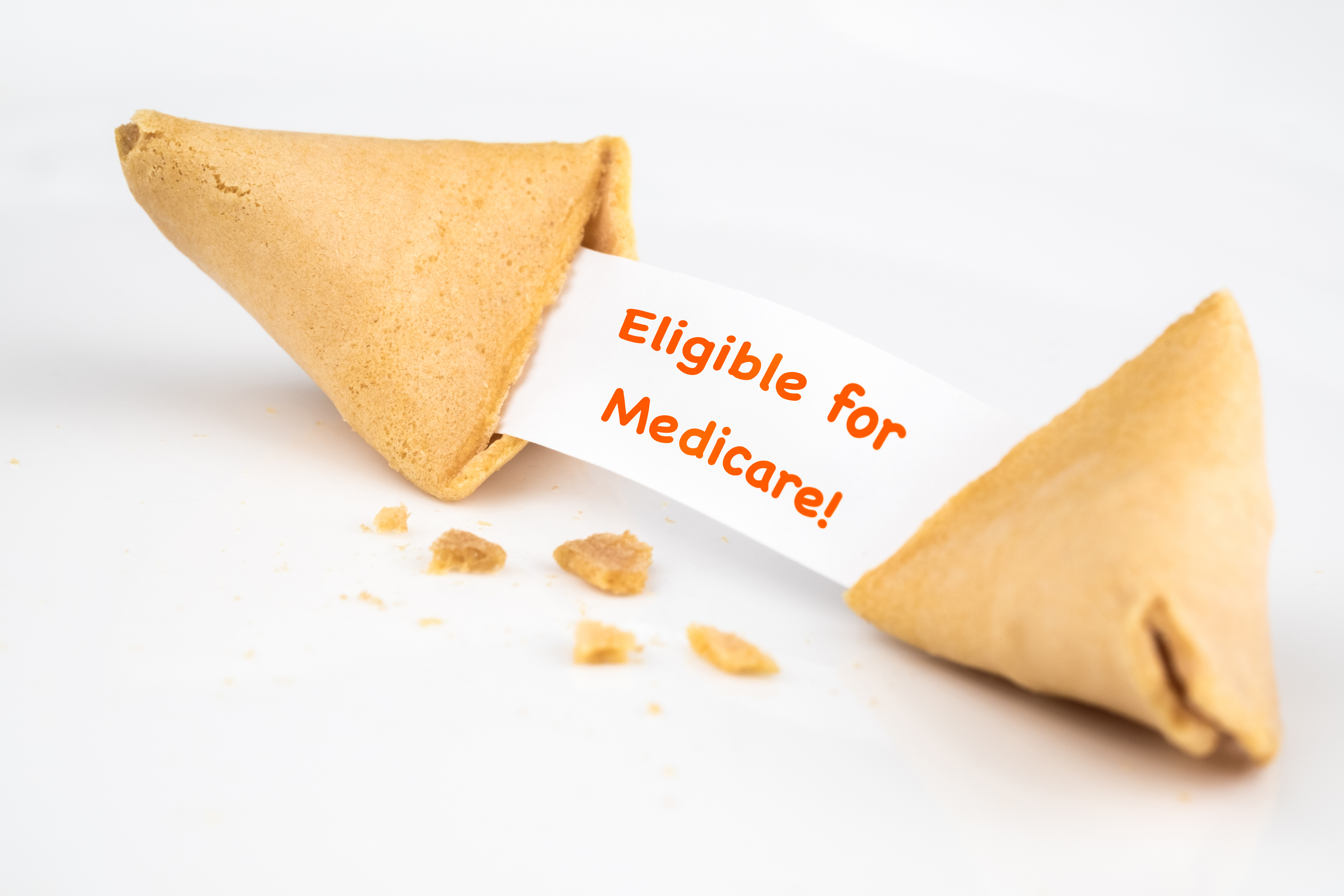 fortune-cookie-with-words-eligible-for-medicare-on-white-paper