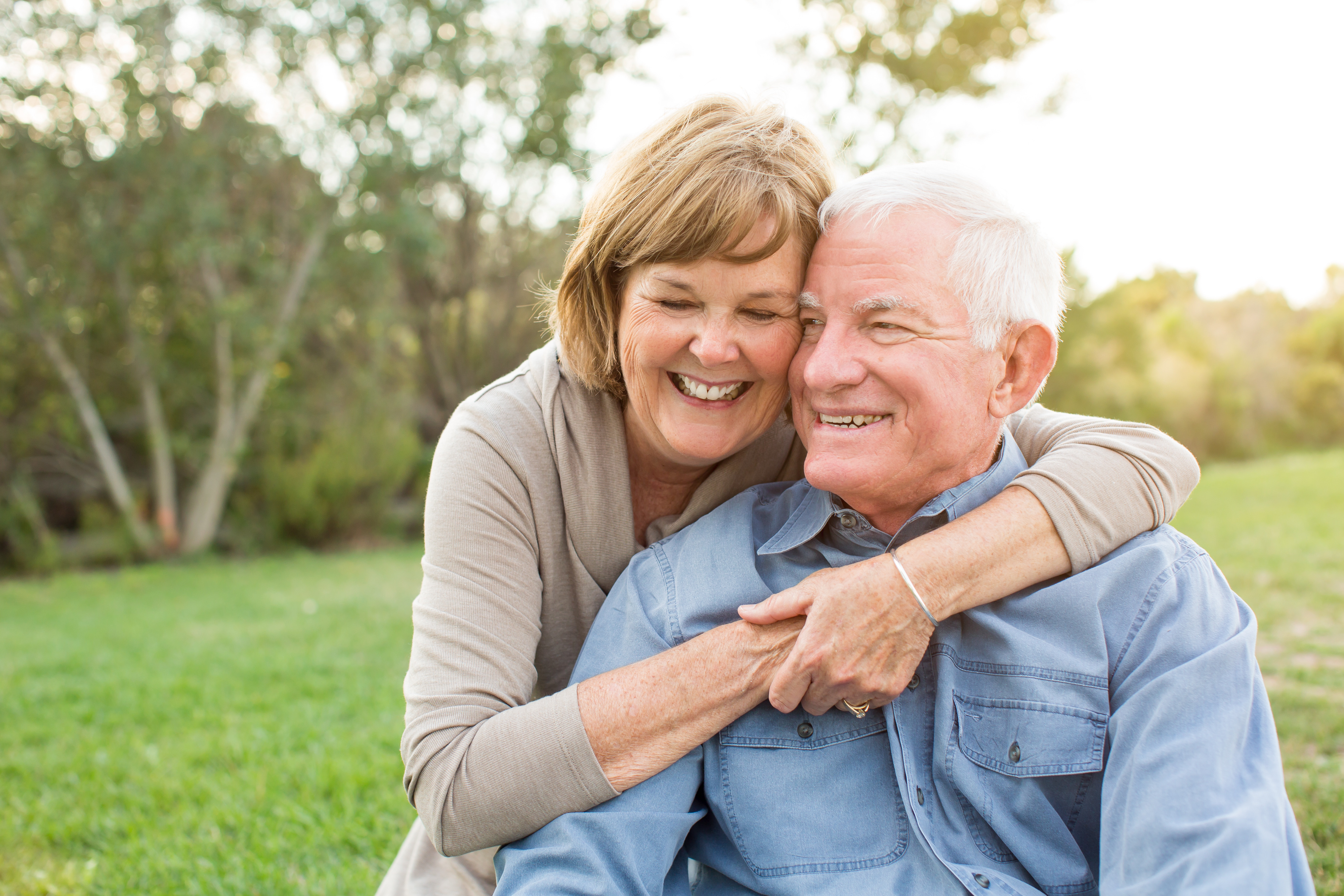 senior-couple-smiling-after-buying-life-insurance-policy