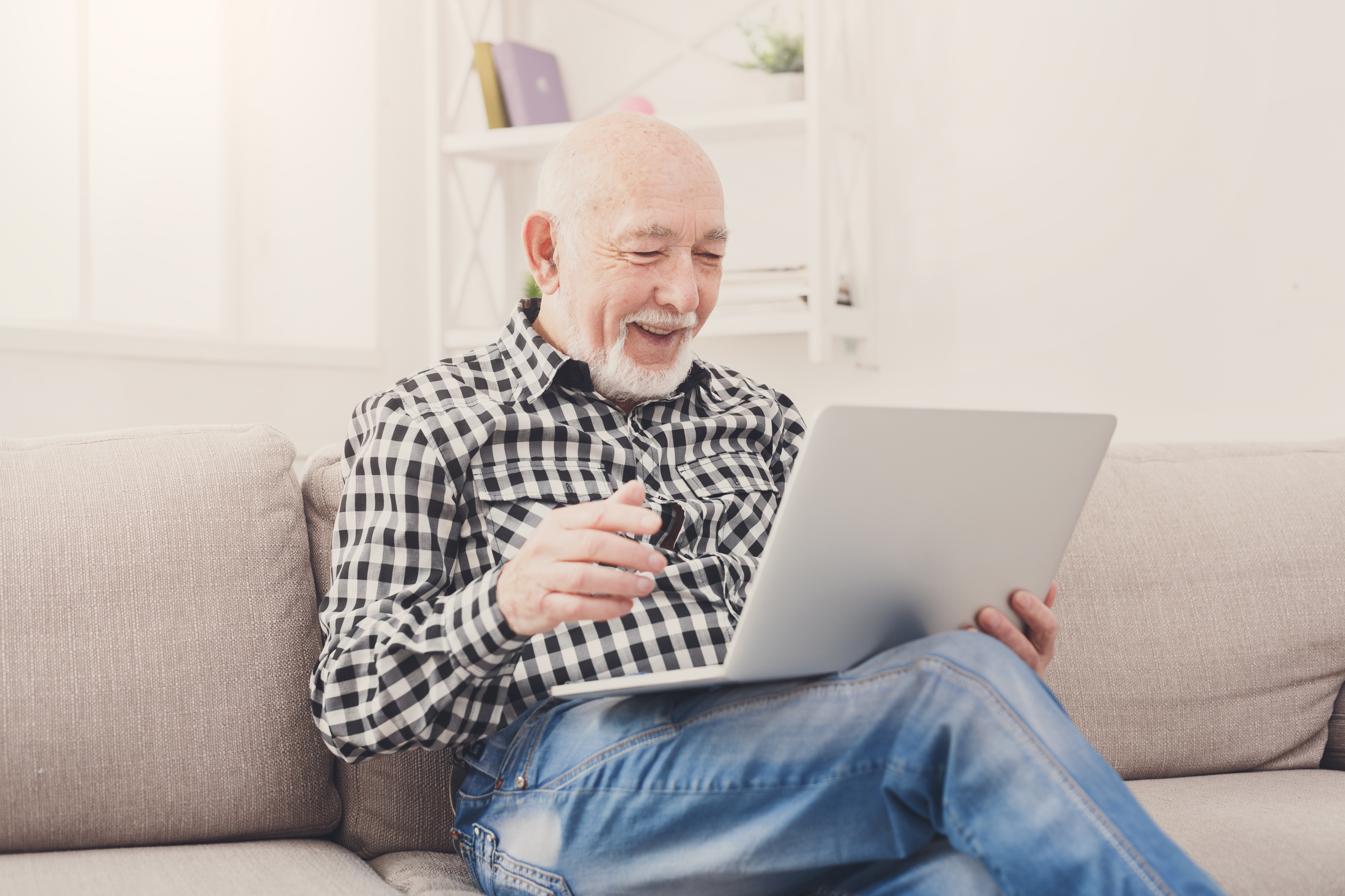 senior-male-using-laptop-to-explore-life-insurance-options-after-testicular-cancer-diagnosis